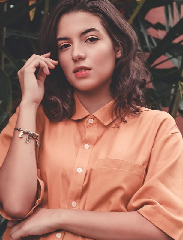 Portrait of a girl with short hair wearing light orange T-shirt